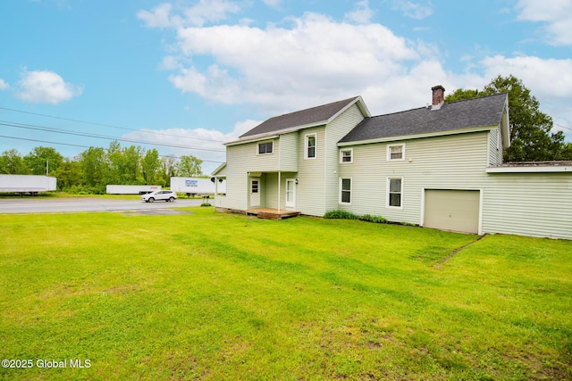 56 Boulevard, Queensbury, NY 12804 - back of property with a chimney, a lawn, driveway, and a garage