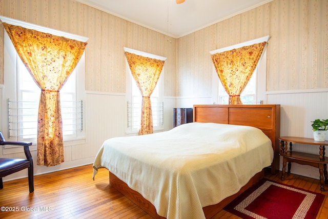 56 Boulevard, Queensbury, NY 12804 - bedroom with wallpapered walls, a wainscoted wall, hardwood / wood-style flooring, and crown molding