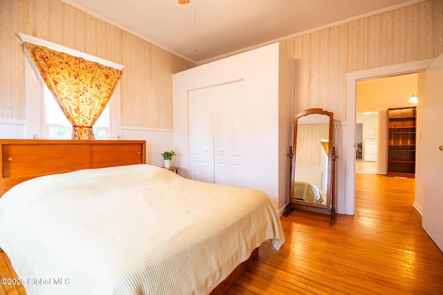 56 Boulevard, Queensbury, NY 12804 - bedroom featuring wallpapered walls, hardwood / wood-style floors, washer / dryer, a closet, and wainscoting