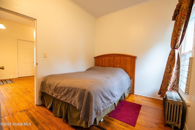 56 Boulevard, Queensbury, NY 12804 - bedroom featuring ornamental molding, radiator heating unit, hardwood / wood-style floors, multiple windows, and baseboards