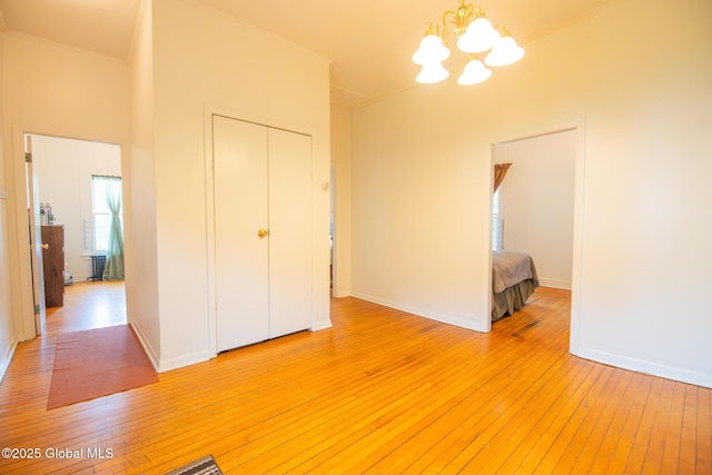 56 Boulevard, Queensbury, NY 12804 - unfurnished dining area featuring light wood finished floors, a chandelier, and baseboards