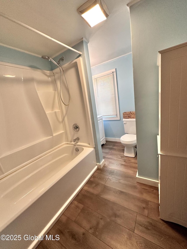 134 Moyer St, Canajoharie, NY 13317 - full bath featuring toilet, wood finished floors, baseboards, and shower / washtub combination