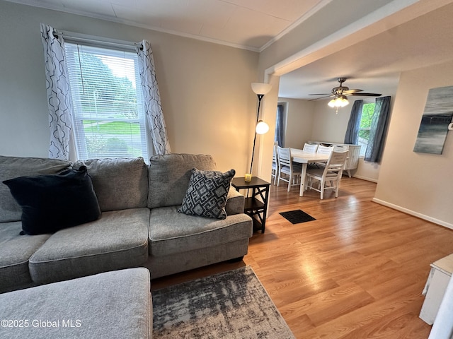 134 Moyer St, Canajoharie, NY 13317 - living room featuring crown molding, a ceiling fan, wood finished floors, and baseboards