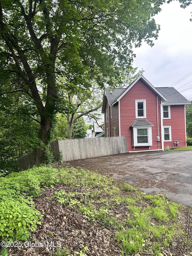 134 Moyer St, Canajoharie, NY 13317 - view of property exterior featuring roof with shingles and asphalt driveway