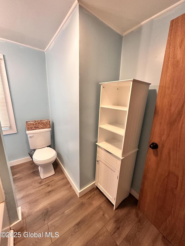 134 Moyer St, Canajoharie, NY 13317 - half bathroom with wood finished floors, toilet, crown molding, and baseboards