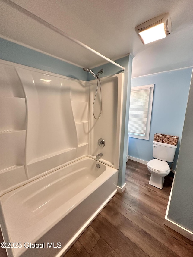 134 Moyer St, Canajoharie, NY 13317 - full bathroom with wood finished floors, toilet, bathtub / shower combination, and baseboards