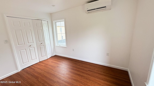 27 Major Dickinson Ave, Stillwater, NY 12170 - unfurnished bedroom featuring a wall mounted air conditioner, wood finished floors, baseboards, and a closet