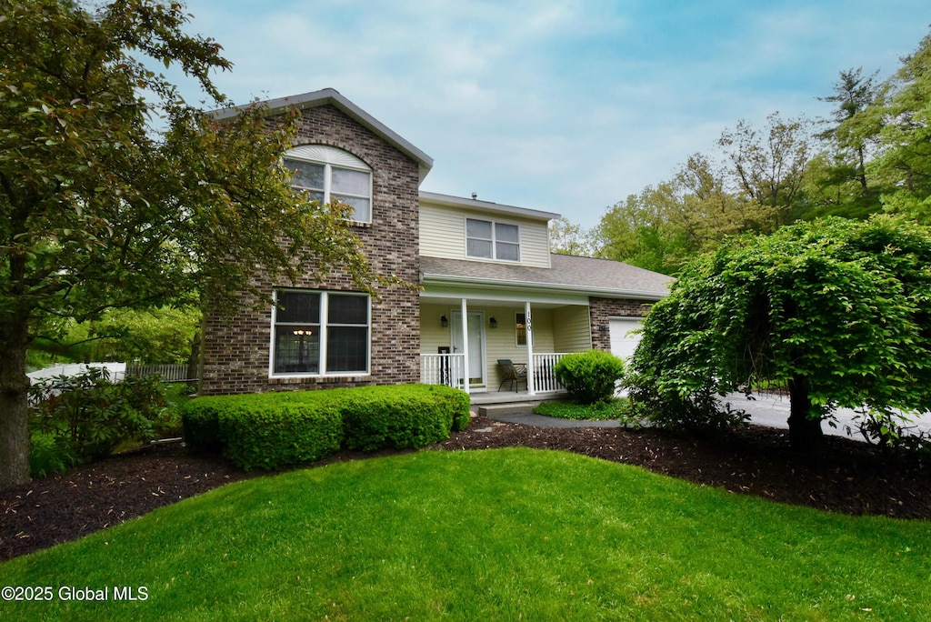100 Kayaderosseras Dr, Milton, NY 12020 - traditional-style house with a porch, a garage, and a front lawn