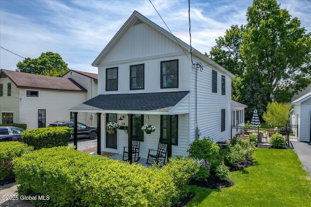 114 York Ave, Saratoga Springs, NY 12866 - view of front of home with roof with shingles, a front lawn, covered porch, and board and batten siding