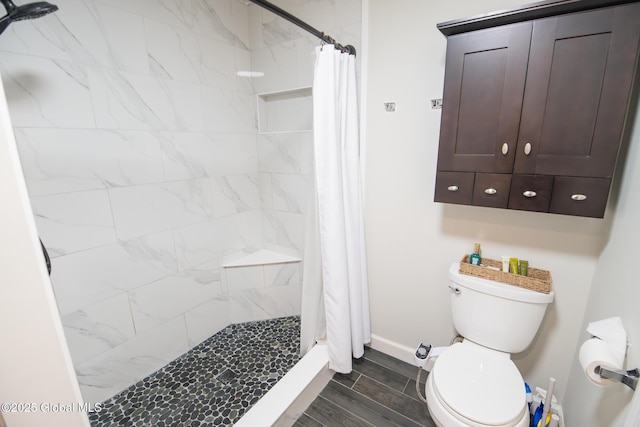 16 Dinu Dr, Warrensburg, NY 12885 - bathroom with toilet, baseboards, a stall shower, and wood tiled floors