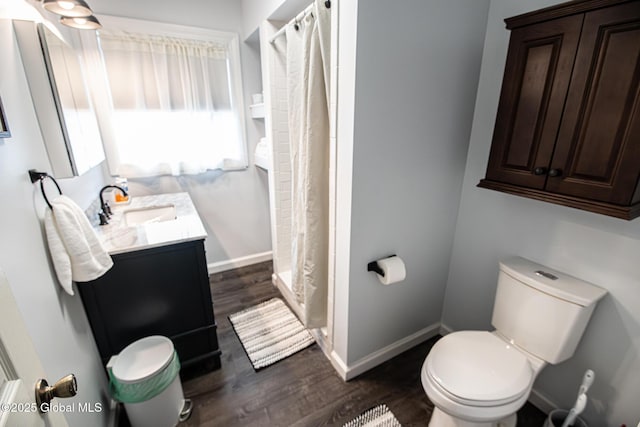 16 Dinu Dr, Warrensburg, NY 12885 - full bathroom with vanity, wood finished floors, toilet, baseboards, and a shower with curtain