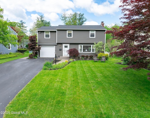 95 Jordan Blvd, Bethlehem, NY 12054 - colonial house with asphalt driveway, a chimney, a garage, and a front yard