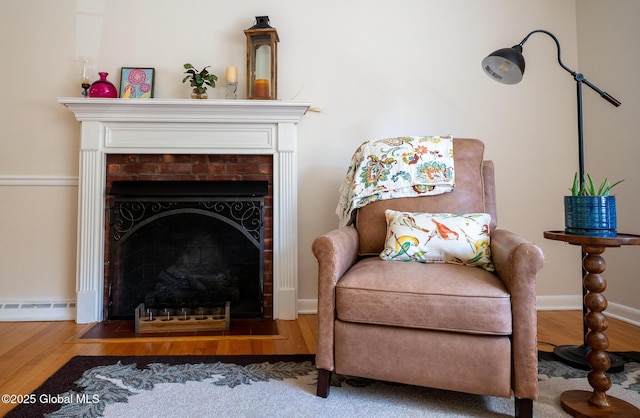95 Jordan Blvd, Bethlehem, NY 12054 - sitting room with a fireplace with flush hearth, wood finished floors, a baseboard radiator, and baseboards