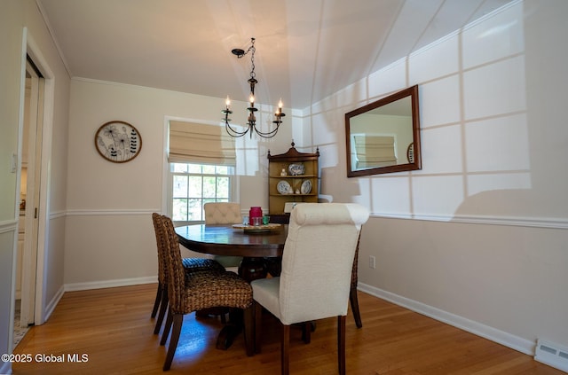 95 Jordan Blvd, Bethlehem, NY 12054 - dining area featuring a chandelier, light wood-style floors, a baseboard heating unit, lofted ceiling, and baseboards