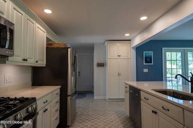 95 Jordan Blvd, Bethlehem, NY 12054 - kitchen with appliances with stainless steel finishes, a sink, white cabinetry, recessed lighting, and baseboards