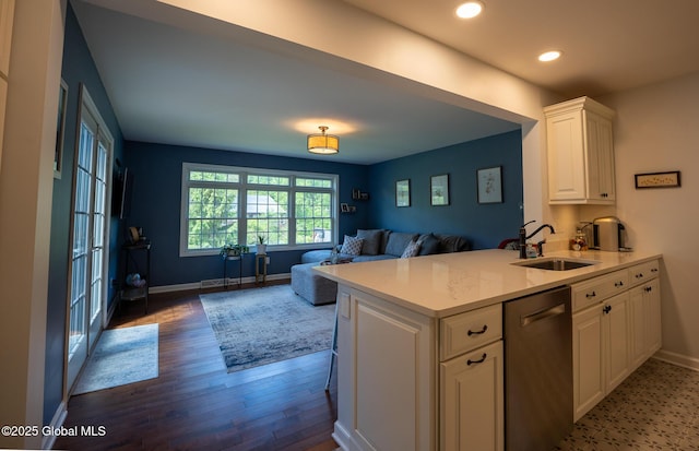 95 Jordan Blvd, Bethlehem, NY 12054 - kitchen featuring a sink, stainless steel dishwasher, light countertops, wood finished floors, and white cabinets