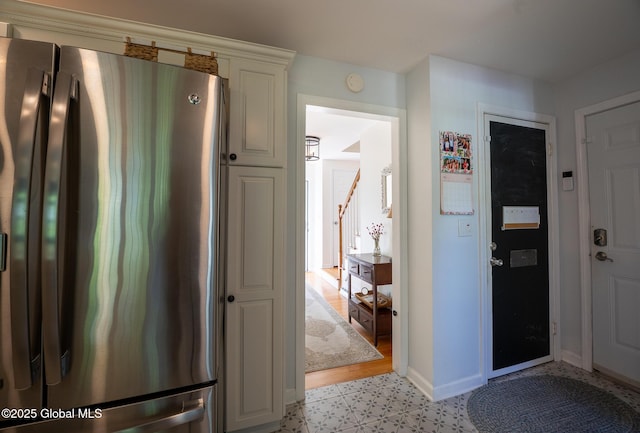 95 Jordan Blvd, Bethlehem, NY 12054 - kitchen with freestanding refrigerator, baseboards, light flooring, and white cabinets