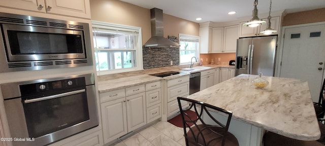 22 E Rd, Brunswick, NY 12180 - kitchen with appliances with stainless steel finishes, wall chimney exhaust hood, a sink, pendant lighting, and white cabinets
