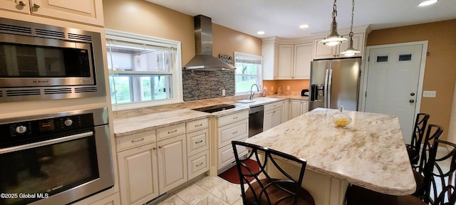 22 E Rd, Brunswick, NY 12180 - kitchen featuring appliances with stainless steel finishes, wall chimney range hood, a breakfast bar area, light stone countertops, and recessed lighting