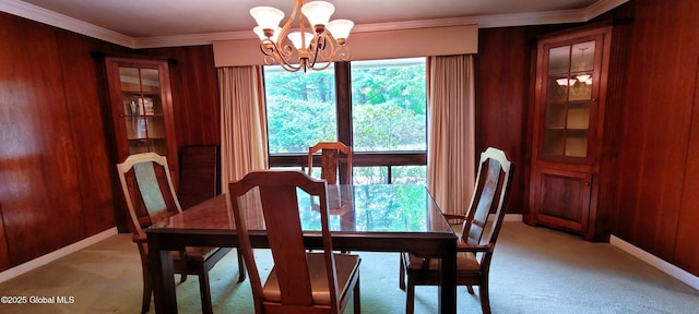 22 E Rd, Brunswick, NY 12180 - dining area featuring a chandelier, light carpet, ornamental molding, wood walls, and baseboards