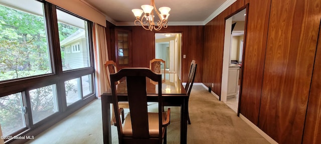 22 E Rd, Brunswick, NY 12180 - dining area with light colored carpet, crown molding, a chandelier, baseboards, and wooden walls