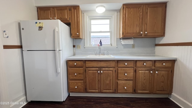 209 Hudson Ave E, East Greenbush, NY 12144 - kitchen with freestanding refrigerator, a sink, brown cabinets, dark wood-style floors, and light countertops