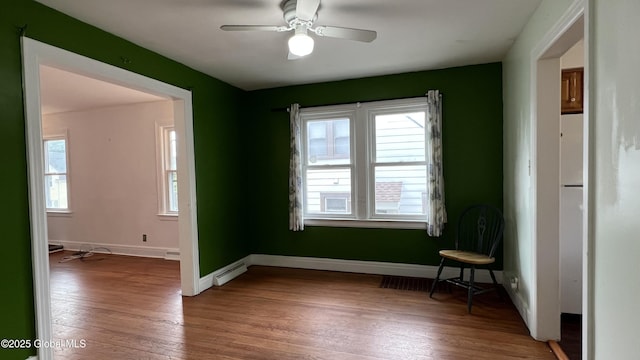 209 Hudson Ave E, East Greenbush, NY 12144 - spare room featuring a baseboard radiator, healthy amount of natural light, wood finished floors, and ceiling fan