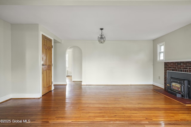 5 Brigadier St, Colonie, NY 12205 - unfurnished living room with arched walkways, light wood-type flooring, and baseboards