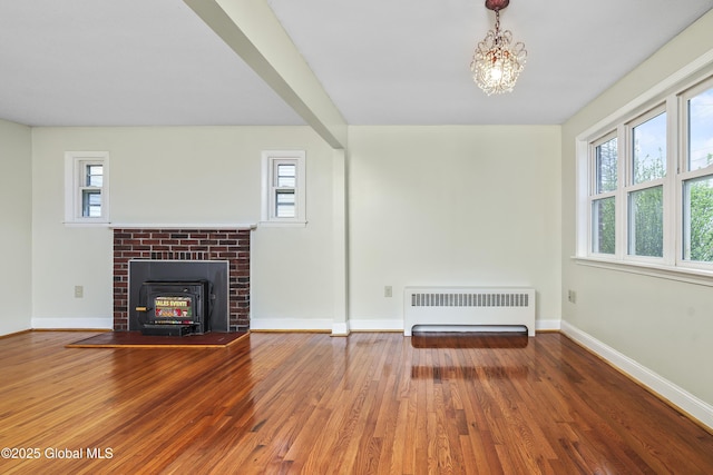 5 Brigadier St, Colonie, NY 12205 - unfurnished living room with radiator heating unit, wood finished floors, and plenty of natural light