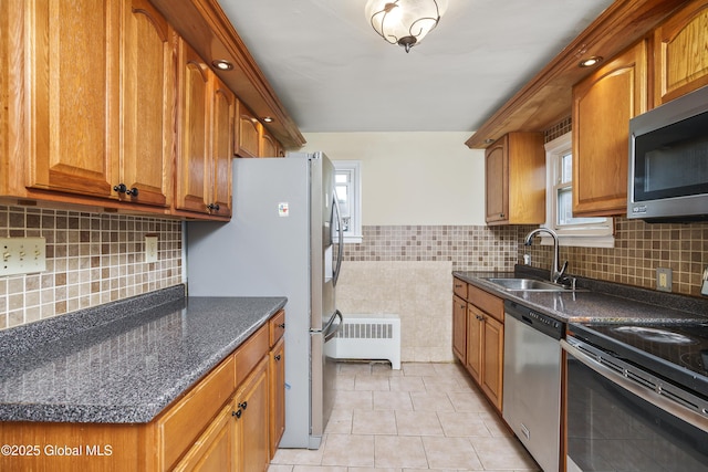 5 Brigadier St, Colonie, NY 12205 - kitchen with appliances with stainless steel finishes, a sink, radiator heating unit, light tile patterned flooring, and brown cabinets