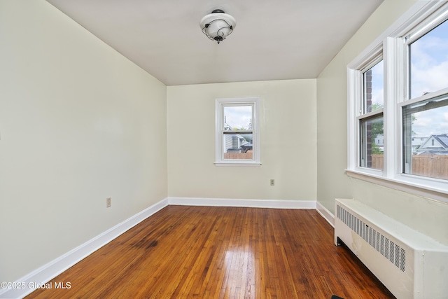 5 Brigadier St, Colonie, NY 12205 - spare room featuring radiator, healthy amount of natural light, baseboards, and hardwood / wood-style floors