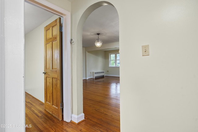 5 Brigadier St, Colonie, NY 12205 - hall with arched walkways, wood-type flooring, radiator heating unit, and baseboards
