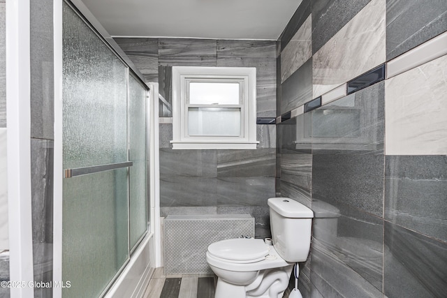 5 Brigadier St, Colonie, NY 12205 - full bath featuring toilet, tile walls, and combined bath / shower with glass door