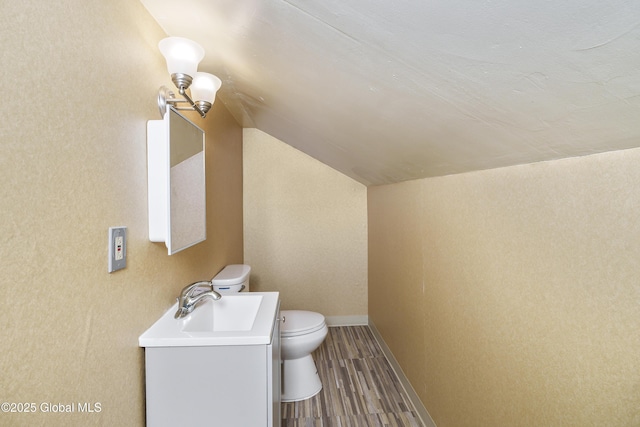 5 Brigadier St, Colonie, NY 12205 - bathroom with vanity, toilet, lofted ceiling, wood finished floors, and baseboards