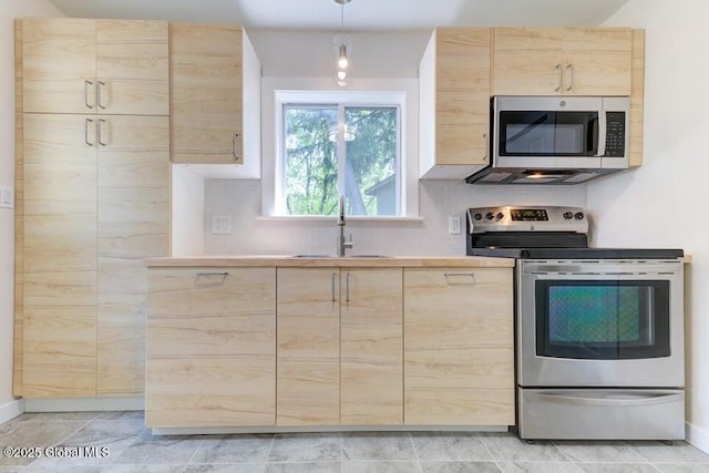 3956 Rte 9 W, Saugerties, NY 12477 - kitchen with light brown cabinets, stainless steel appliances, a sink, and tasteful backsplash