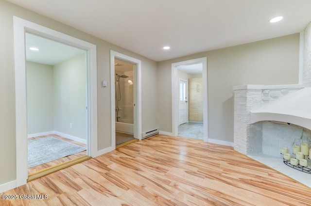 3956 Rte 9 W, Saugerties, NY 12477 - unfurnished living room with baseboard heating, wood finished floors, recessed lighting, a fireplace with flush hearth, and baseboards