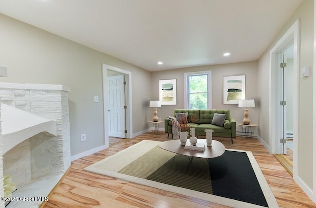 3956 Rte 9 W, Saugerties, NY 12477 - living room with light wood-type flooring, a baseboard radiator, recessed lighting, baseboards, and a stone fireplace