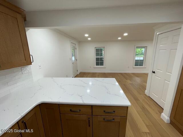 3916 State Highway 2, Brunswick, NY 12180 - kitchen featuring a peninsula, light wood-style floors, light stone counters, open floor plan, and recessed lighting