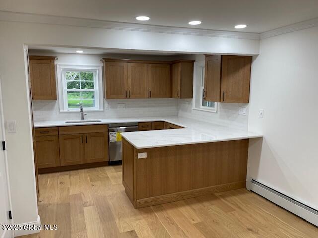 3916 State Highway 2, Brunswick, NY 12180 - kitchen featuring stainless steel dishwasher, a baseboard radiator, light wood-style flooring, a peninsula, and crown molding
