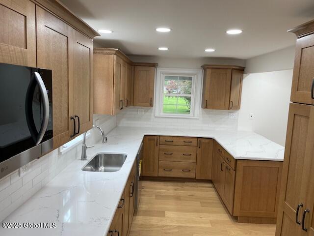 3916 State Highway 2, Brunswick, NY 12180 - kitchen featuring a sink, light stone counters, decorative backsplash, light wood-style floors, and recessed lighting