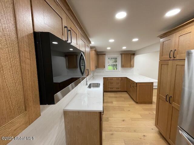 3916 State Highway 2, Brunswick, NY 12180 - kitchen with a sink, freestanding refrigerator, light wood-type flooring, black microwave, and recessed lighting