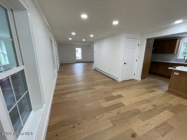 3916 State Highway 2, Brunswick, NY 12180 - interior space featuring recessed lighting, light wood-style flooring, a baseboard radiator, ornamental molding, and baseboards