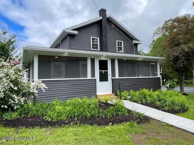 3916 State Highway 2, Brunswick, NY 12180 - view of front facade featuring entry steps, a sunroom, and a chimney