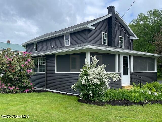 3916 State Highway 2, Brunswick, NY 12180 - view of home's exterior featuring a yard, a chimney, a sunroom, and entry steps