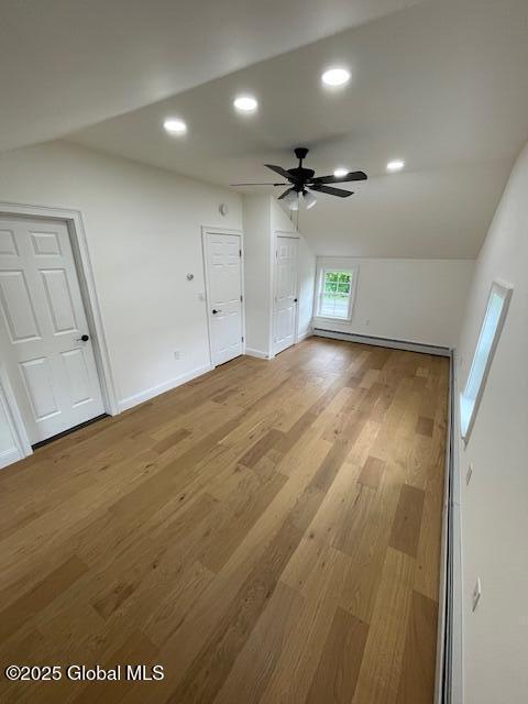 3916 State Highway 2, Brunswick, NY 12180 - unfurnished living room with lofted ceiling, a baseboard heating unit, light wood-style flooring, ceiling fan, and recessed lighting