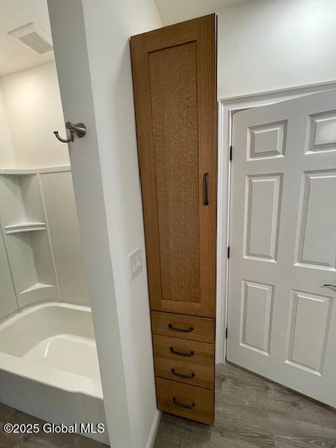3916 State Highway 2, Brunswick, NY 12180 - bathroom featuring wood finished floors, bathing tub / shower combination, and built in features