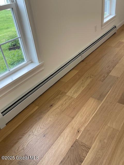 3916 State Highway 2, Brunswick, NY 12180 - detailed view of wood finished floors and a baseboard heating unit