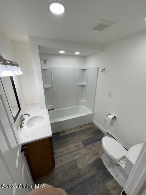 3916 State Highway 2, Brunswick, NY 12180 - full bath featuring toilet, vanity, shower / bath combination, wood finished floors, and baseboards