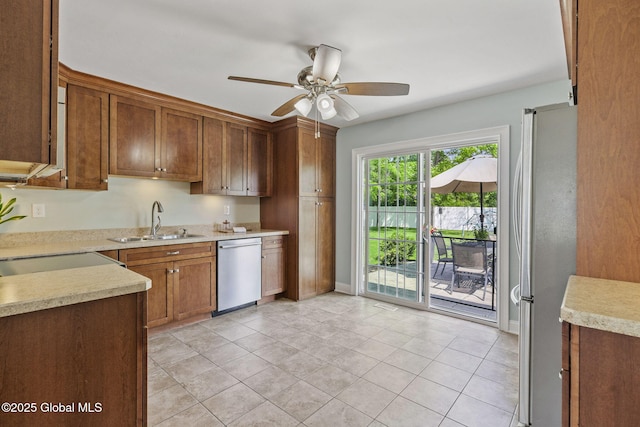 11 Thatcher Dr, Altamont, NY 12009 - kitchen featuring stainless steel appliances, ceiling fan, light countertops, light tile patterned floors, and brown cabinets