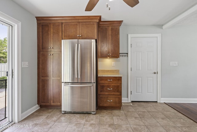 11 Thatcher Dr, Altamont, NY 12009 - kitchen with freestanding refrigerator, ceiling fan, light countertops, and brown cabinets